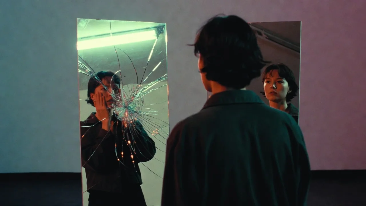 Person standing between two mirrors - one cracked and distorted, one clear and calm - representing the difference between self-consciousness and self-awareness